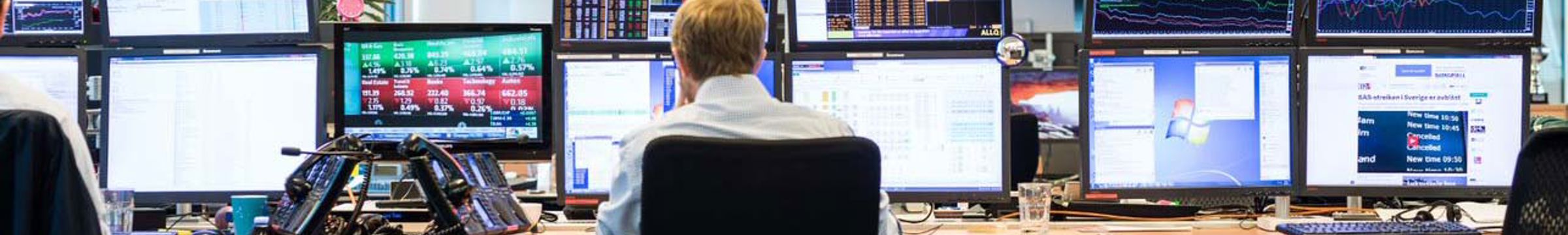 Man in front of computers